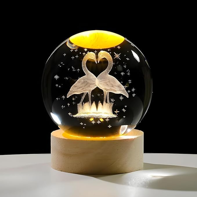 Flamingo crystal ball night lamp lit warm white on its wooden base
