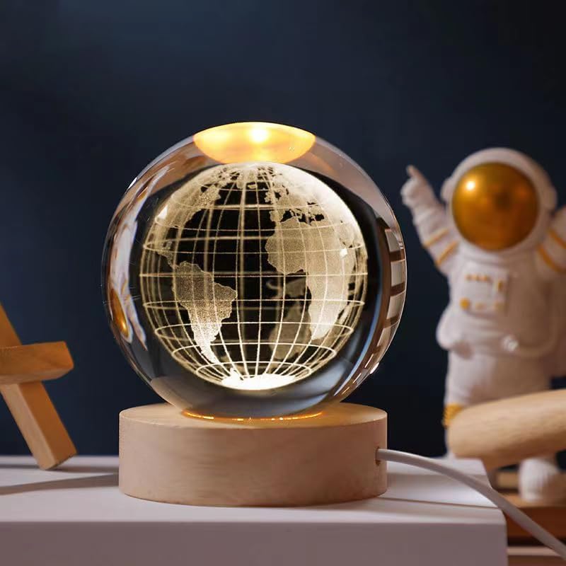 Earth crystal ball night lamp lit warm white on its wooden base