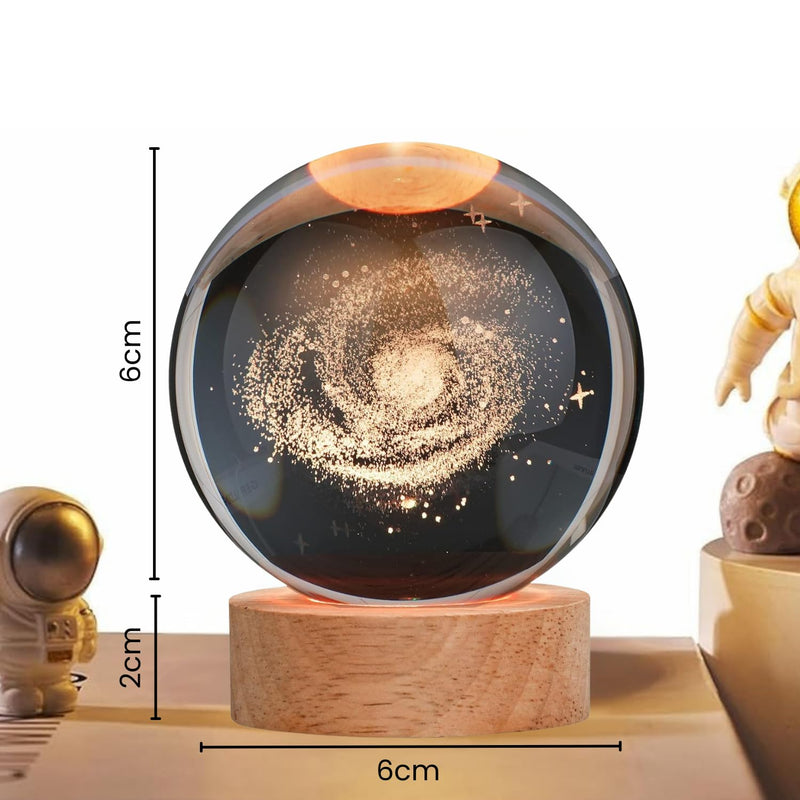 3D crystal ball night lamp lit warm white on a solid wooden base